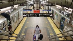 A commuters walks on a nearly empty subway platform in New York, Monday, June 8, 2020. After three months of a coronavirus crisis followed by protests and unrest, New York City is trying to turn a page when a limited range of industries reopen Monday. (AP Photo/Seth Wenig)