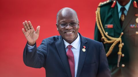 Tanzanian President John Magufuli waves during the inauguration of Incumbent South African President Cyril Ramaphosa in Pretoria on May 25, 2019. 