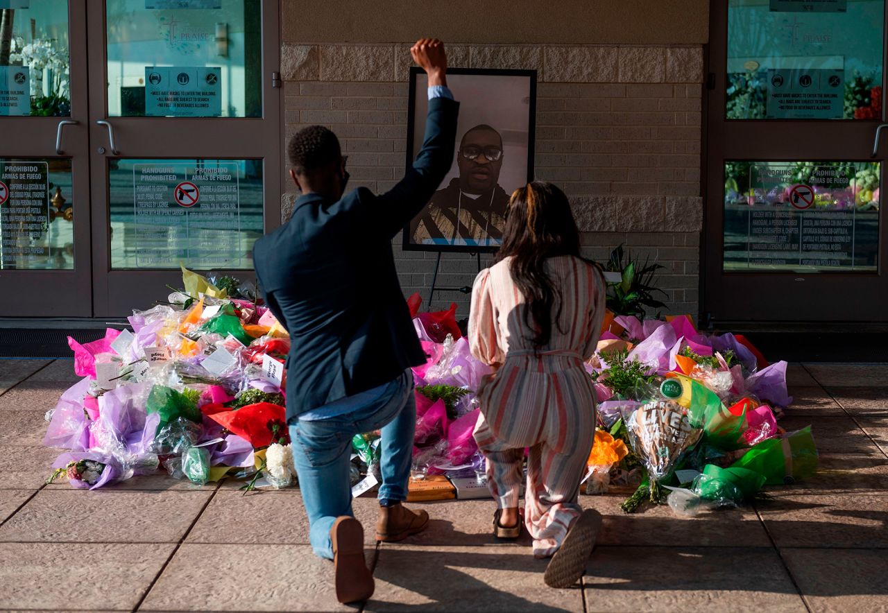 People pay their respects at a Floyd memorial in Houston on Tuesday.