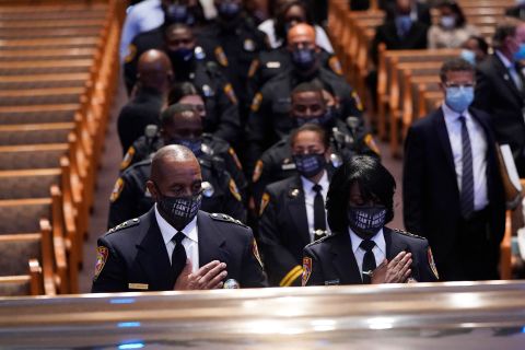 Members of the Texas Southern University Police Department pause during Floyd's funeral.