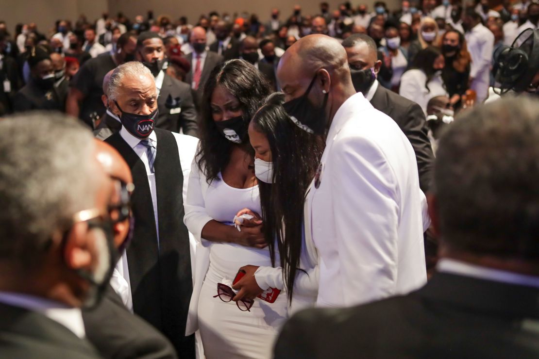 Family members react as they view the casket during the funeral of George Floyd on Tuesday at The Fountain of Praise church in Houston, Texas.