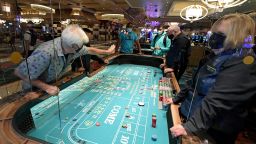 LAS VEGAS, NEVADA - JUNE 04:  Guests play craps on a table with plexiglass safety shields at Bellagio Resort & Casino on the Las Vegas Strip after the property opened for the first time since being closed on March 17 because of the coronavirus (COVID-19) pandemic on June 4, 2020 in Las Vegas, Nevada. MGM Resorts International is requiring guests to wear masks at all of their craps tables since players have to reach across the gaming area to play. Hotel-casinos throughout the state are opening today as part of a phased reopening of the economy with social distancing guidelines and other restrictions in place. MGM Resorts International reopened Bellagio, New York-New York Hotel & Casino, MGM Grand Hotel & Casino and The Signature today.  (Photo by Ethan Miller/Getty Images)