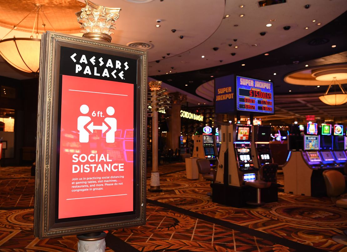 Social distancing signs, such as this one at Caesars Palace, did not deter some visitors from congregating.