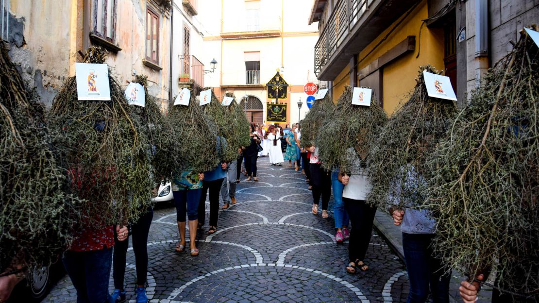 An annual festival sees locals dress in unusual bell-shaped bundles of branches.
