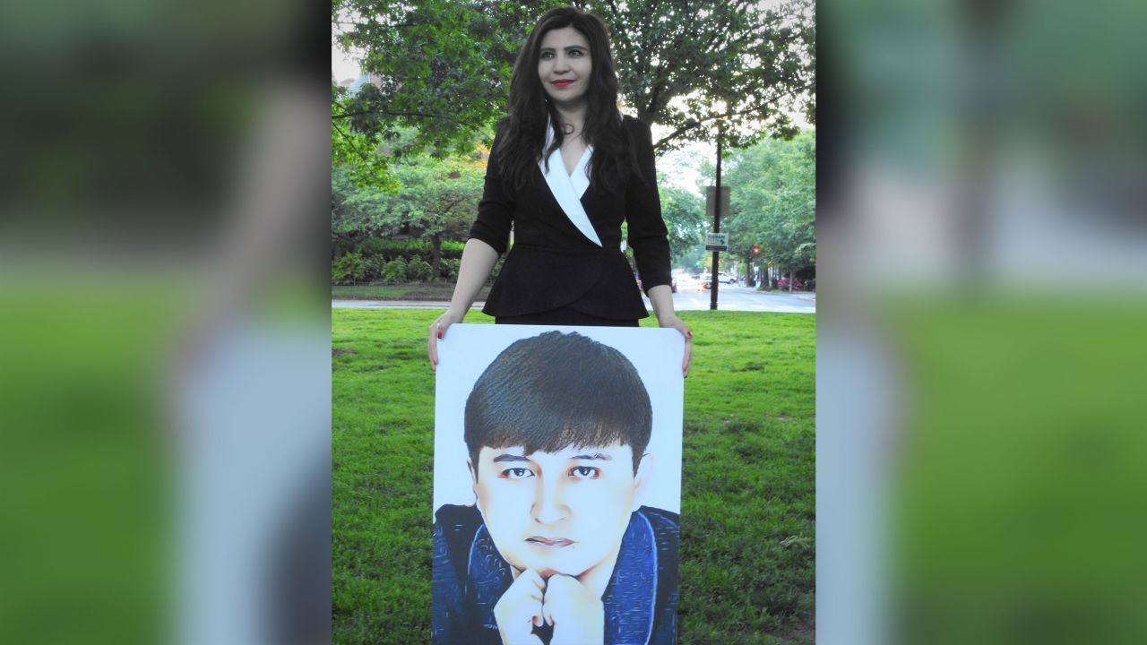 Rayhan Asat holds a picture of her brother, Ekpar Asat, in this photo from May 2020.