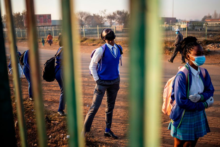 Students at the Winnie Mandela Secondary School wait in line before classes resumed in Tembisa, South Africa, on June 8. Students began returning to classrooms after two and a half months of home-schooling.