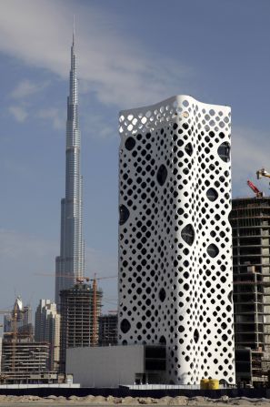 The O-14 commercial tower has a perforated concrete shell which protects the inside from lateral forces, allowing interiors to be <a href="index.php?page=&url=https%3A%2F%2Fwww.emporis.com%2Fbuildings%2F281030%2Fo-14-dubai-united-arab-emirates" target="_blank" target="_blank">largely column-free</a>. Completed in 2009, a meter-wide gap between the shell and interior acts like a chimney, causing air to rise up and out while cooling window surfaces.