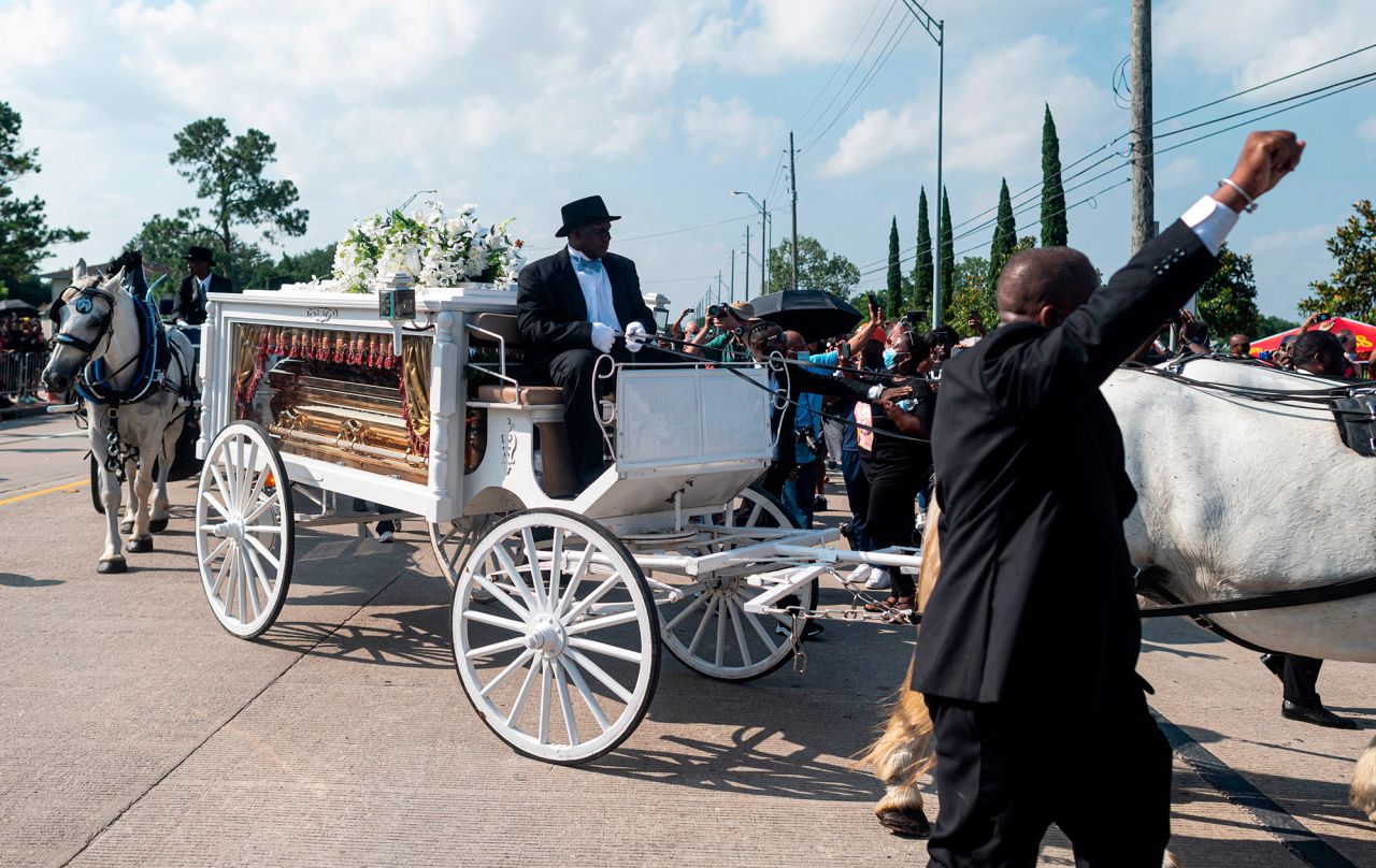 A horse-drawn carriage carries Floyd's casket to Houston Memorial Gardens.