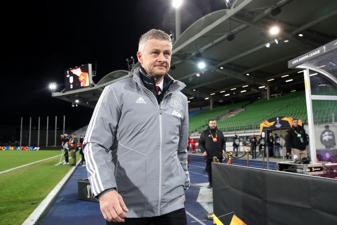 Solskjaer walks to his seat prior to the UEFA Europa League round of 16 first leg match against LASK.