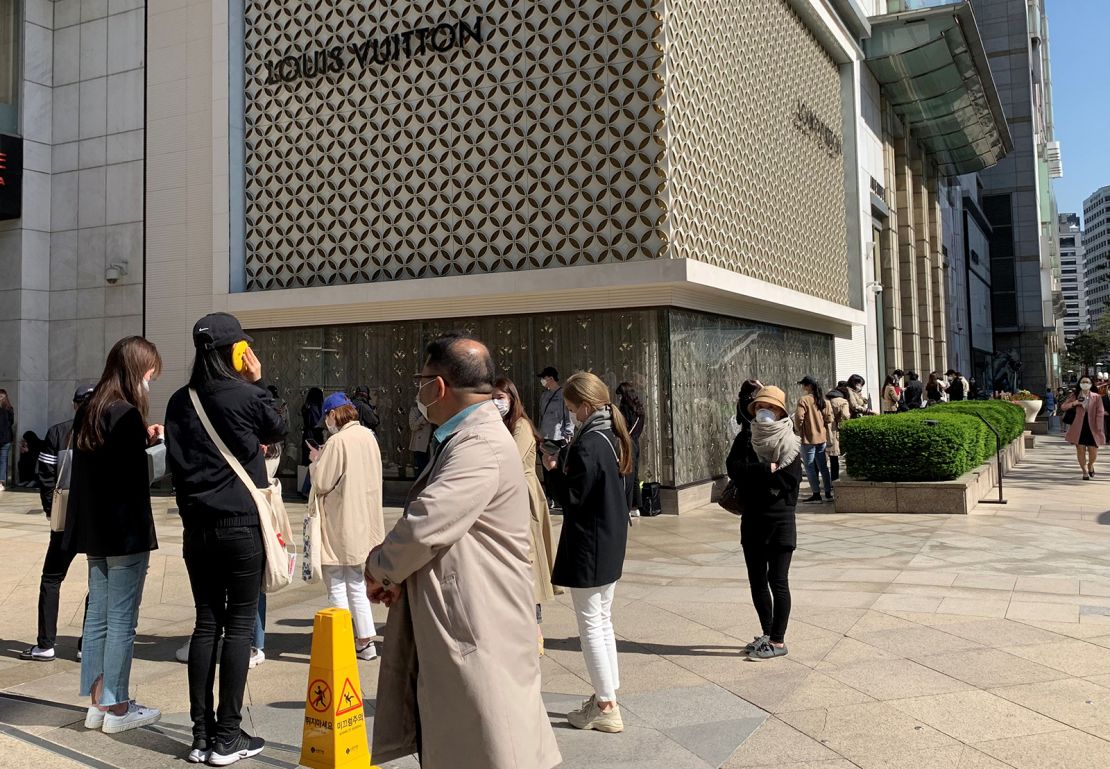 Shoppers lining up to enter a Louis Vuitton boutique in Seoul in May. "South Korea is almost mirroring what's happening in China," said Fflur Roberts, an analyst at Euromonitor.