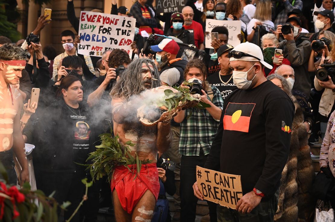 Aboriginal protesters perform a traditional smoking ceremony before the start of a Black Lives Matter demonstration in Sydney in June 2020.