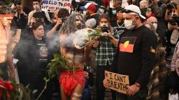 Aboriginal protesters perform a traditional smoking ceremony before the start of a Black Lives Matter demonstration to express solidarity with US protestors in Sydney on June 6, 2020.