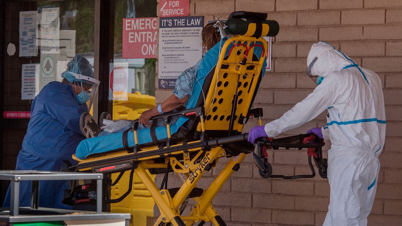 A patient is taken from an ambulance to the emergency room of a hospital in the Navajo Nation town of Tuba City.
