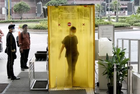 A woman is sprayed with disinfectant before entering a shopping mall in Jakarta, Indonesia, on June 9, 2020.