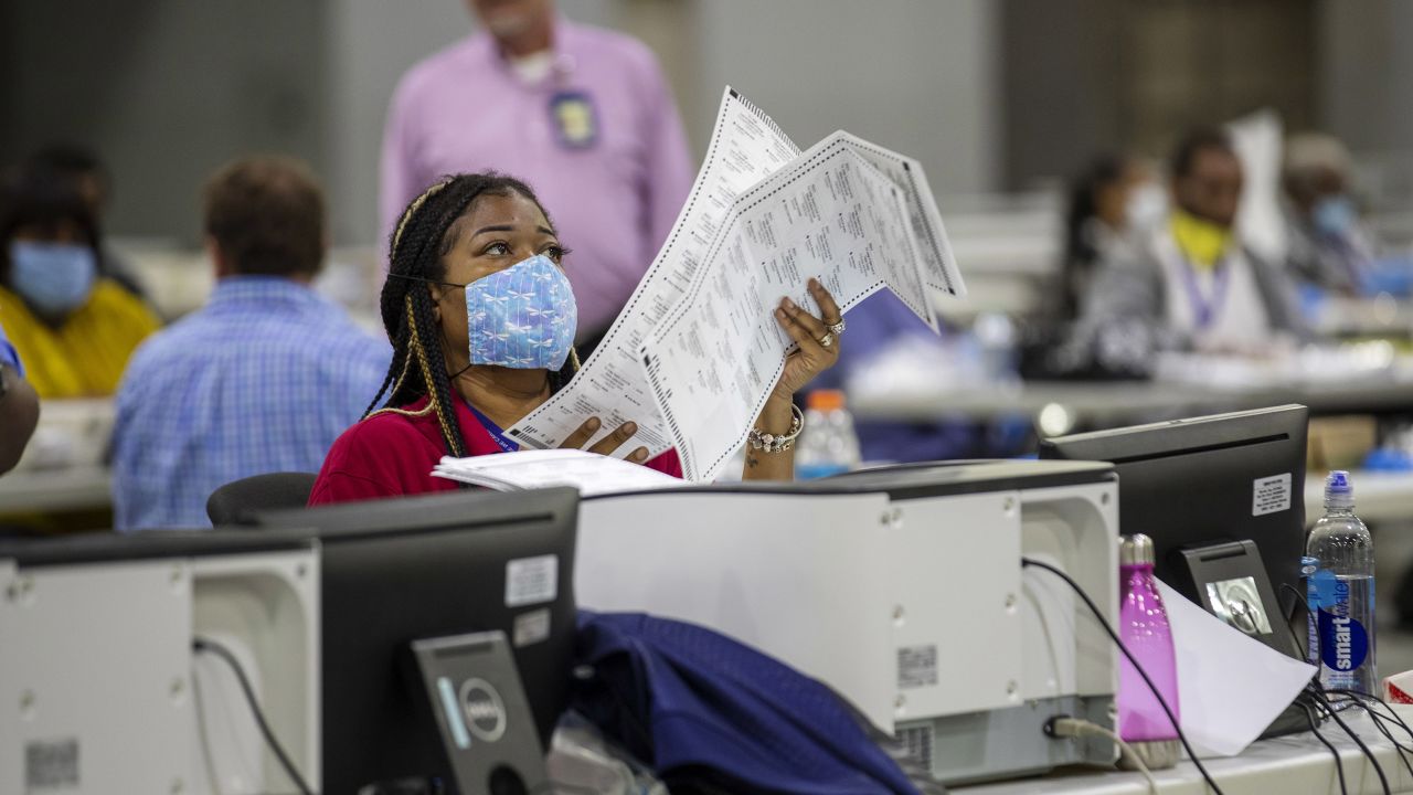 Fulton County employee Shaye Moss scans mail-in paper ballots at the Georgia World Congress Center during the Georgia primary elections in Atlanta on Tuesday, June 9, 2020. (Alyssa Pointer/Atlanta Journal-Constitution via AP)