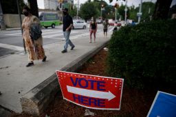 People wait in a line to vote in the Georgia's primary election at Park Tavern on Tuesday, June 9, 2020, in Atlanta. 