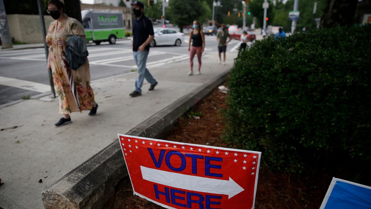 People wait in a line to vote in the Georgia's primary election at Park Tavern on Tuesday, June 9, 2020, in Atlanta. 
