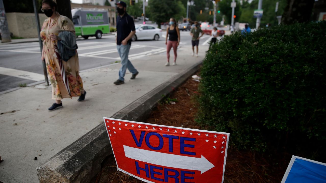 People wait in a line to vote in the Georgia's primary election at Park Tavern on Tuesday, June 9, 2020, in Atlanta.