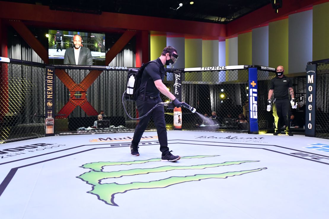 Workers sanitize the Octagon at UFC APEX, the UFC's bespoke arena. 
