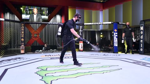 Workers sanitize the Octagon at UFC APEX, the UFC's bespoke arena. 