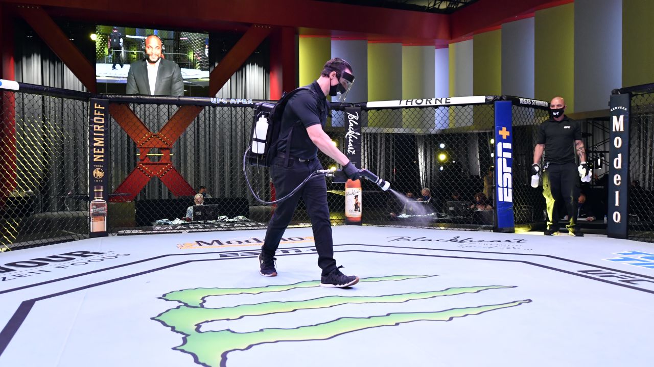 Workers sanitize the Octagon at UFC APEX, the UFC's bespoke arena.