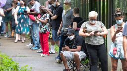 Steven Posey checks his phone as he waits in line to vote, Tuesday, June 9, 2020, at Central Park in Atlanta. Voters reported wait times of three hours. 