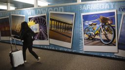A traveler passes in front of posters advertising New Jersey attractions at Newark International Airport (EWR) in Newark, New Jersey, U.S., on Tuesday, June 9, 2020. Airline losses are surging to unprecedented levels expected to be more than three times those following the 2008 global economic slump, according to the industry's main trade group. Photographer: Angus Mordant/Bloomberg via Getty Images