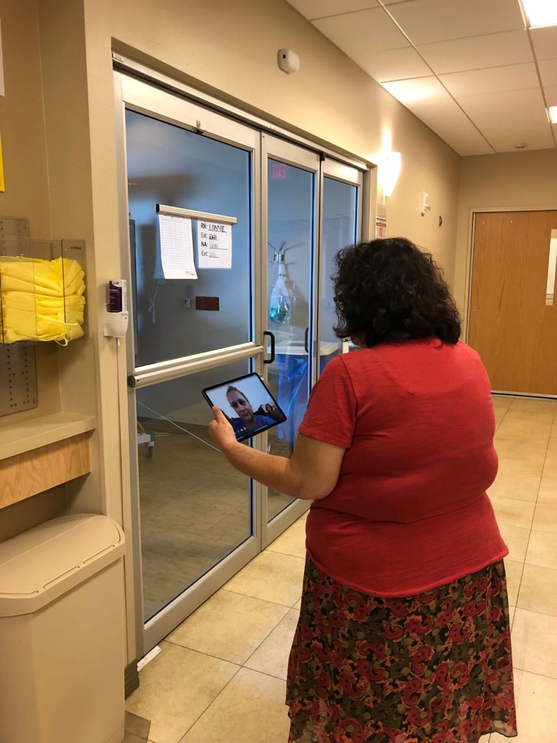 Chaplain Melinda Plumley can't visit coronavirus patients in their rooms and uses an iPad to communicate remotely.