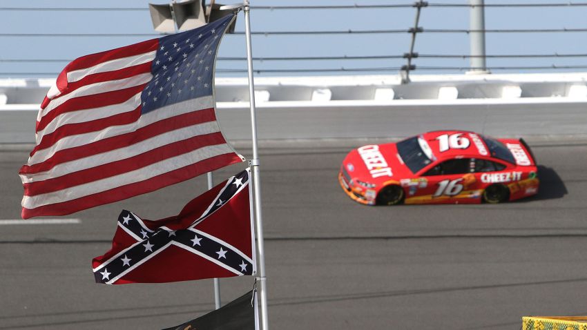 Sprint Cup Series driver Greg Biffle (16) speeds through turn 4 where a confederate flag is posted during the 57th Annual NASCAR Coke Zero 400 practice session at Daytona International Speedway on Friday, July 3, 2015 in Daytona Beach, Florida.  (AP Photo/Alex Menendez)