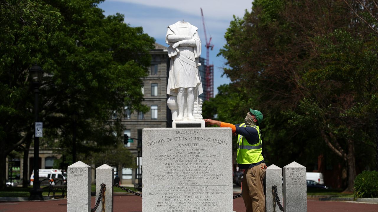 A parks worker inspects a statue of Christopher Columbus that had its head removed at Christopher Columbus Waterfront Park on June 10 in Boston, Massachusetts.
