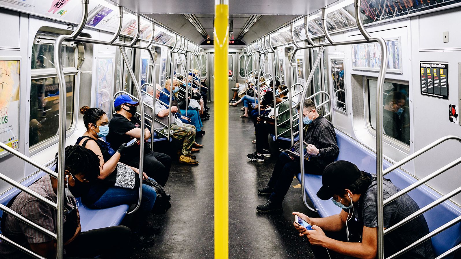 Commuters wear protective masks as they ride a subway train in New York on June 8.