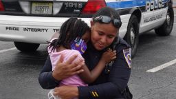 HALLANDALE BEACH, FLORIDA - JUNE 03:  Amora Collins, 4, hugs Hallandale Beach police officer Capt. Megan Jones during a protest  being held against police brutality as well as the recent death of George Floyd on June 03, 2020 in Hallandale Beach, Florida. Protests continue to be held in cities throughout the country over the death of George Floyd, who was killed while in police custody in Minneapolis on May 25th.  (Photo by Joe Raedle/Getty Images)