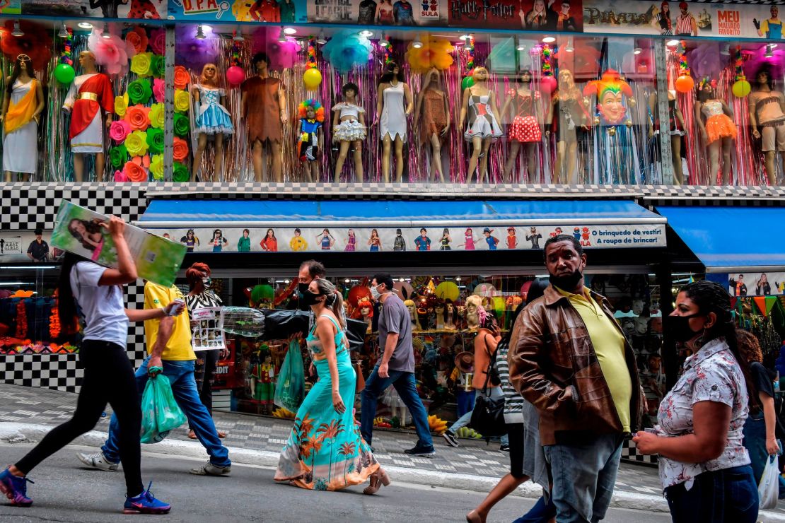 People walk along a street in downtown Sao Paulo, Brazil on Wednesday.