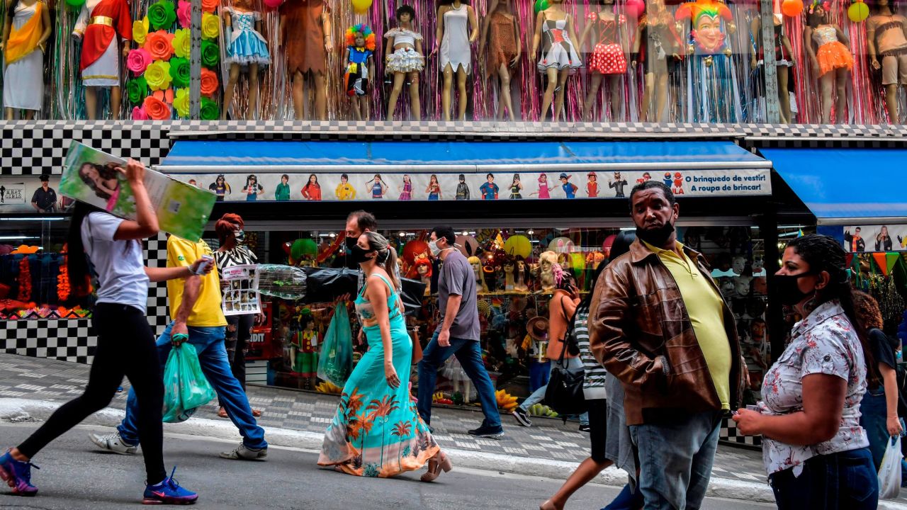 People walk along a street in downtown Sao Paulo, Brazil on Wednesday.