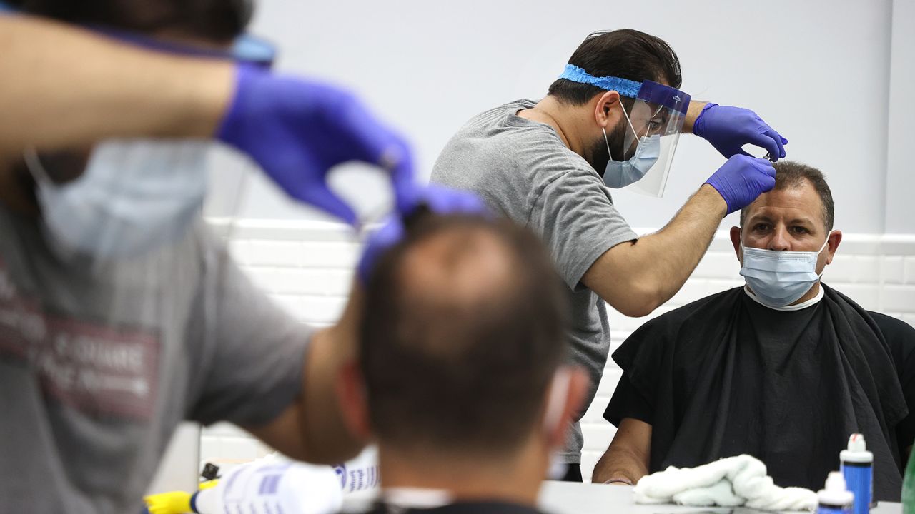 Edward Bababekov cuts the hair of Frank Galiano at Barber Crew by Yury on June 10, in Bellmore, New York.