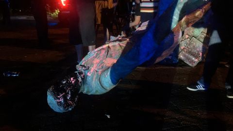 The statue of Confederate President Jefferson Davis is splattered with paint after it was toppled Wednesday night along Monument Drive in Richmond