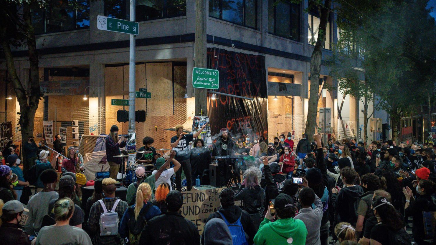 A band plays a free show in front of the Seattle Police Department's East Precinct in the so-called "Capitol Hill Autonomous Zone" on Wednesday in Seattle, Washington.