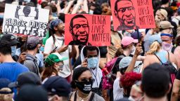 WASHINGTON, DC - JUNE 06: Protesters walk along the recently renamed Black Lives Matter Plaza with signs near the White House during George Floyd protests on June 6, 2020 in Washington, D.C. This is the 12th day of protests since George Floyd died in Minneapolis police custody on May 25. (Photo by Samuel Corum/Getty Images)
