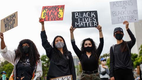 Sheba Sahlemariam (left), from Los Angeles, Vicky Van, from San Gabriel, Raven Ramos, from Culver City and Jasmine chow, from San Gabriel, joined nearly 1,000 people gathered to protest the death of George Floyd, in downtown Los Angeles, on June 5.