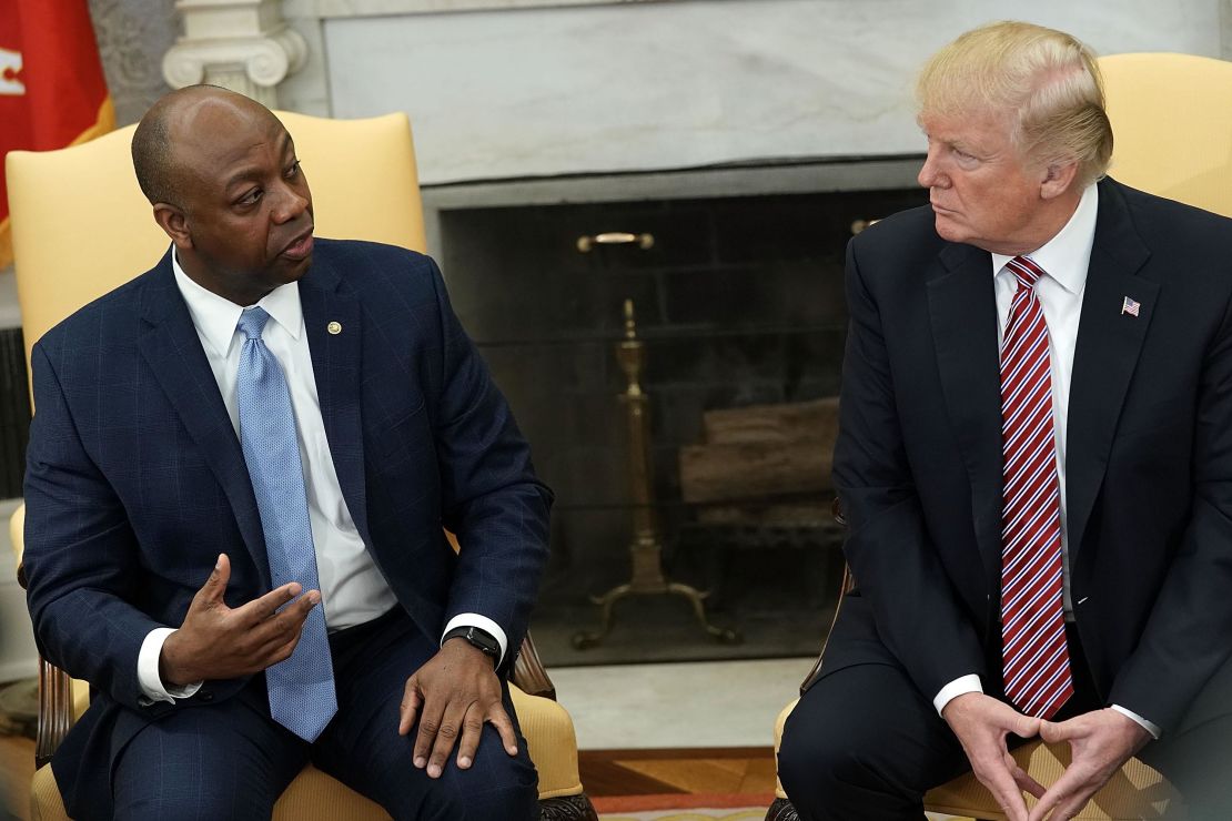 President Donald Trump listens to Sen. Tim Scott during a working session in the Oval Office of the White House in February 2018. 