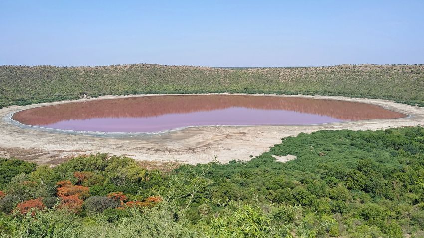 A general view of Lonar crater sanctuary lake is pictured in Buldhana district of Maharashtra state on June 11, 2020. - The lake has turned pink in colour which is believed that when the water level goes down, the salinity increases and warm water gives a rise to algae that tends to absord sunlight and changes the colour of the water, local media reported. (Photo by Santosh JADHAV / AFP) (Photo by SANTOSH JADHAV/AFP via Getty Images)