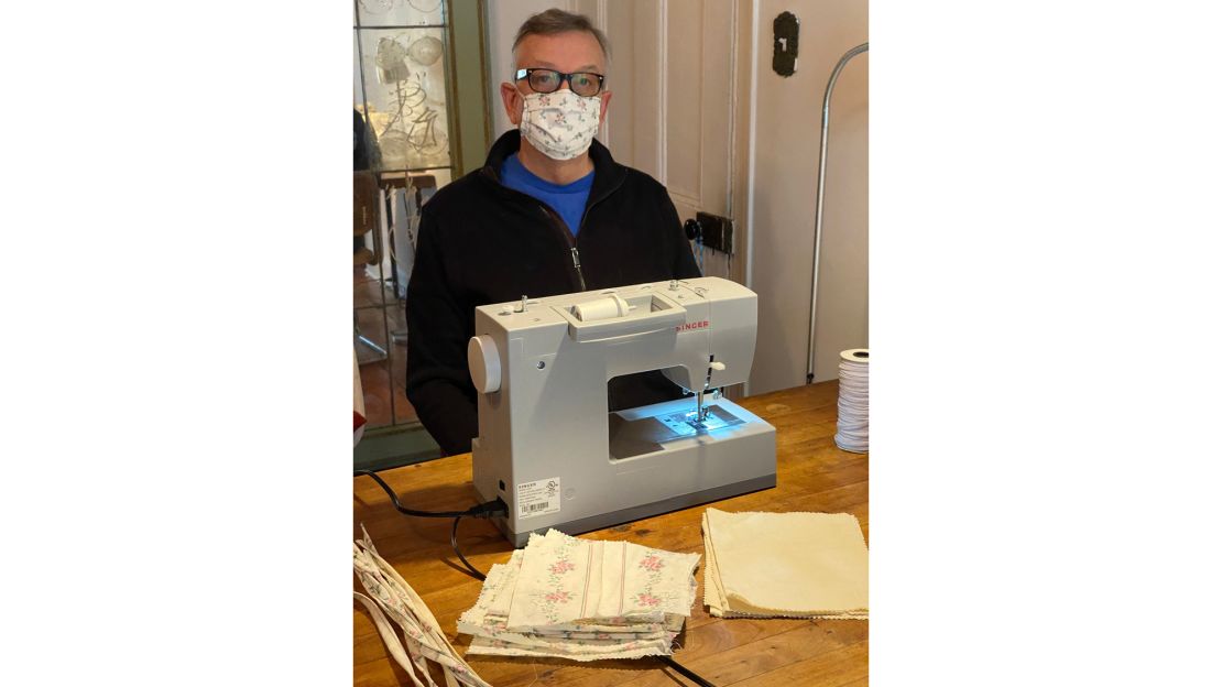 A man uses a sewing machine to create homemade face masks during lockdown in New York City