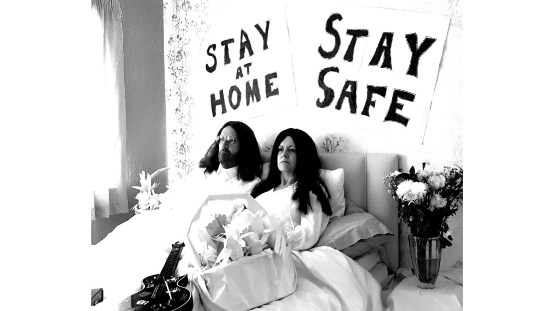 A tongue-in-cheek recreation of John Lennon and Yoko Ono's Bed-Ins for Peace, with the slogans 'Stay at Home' and 'Stay Safe', taken during lockdown in Milton Keynes, England