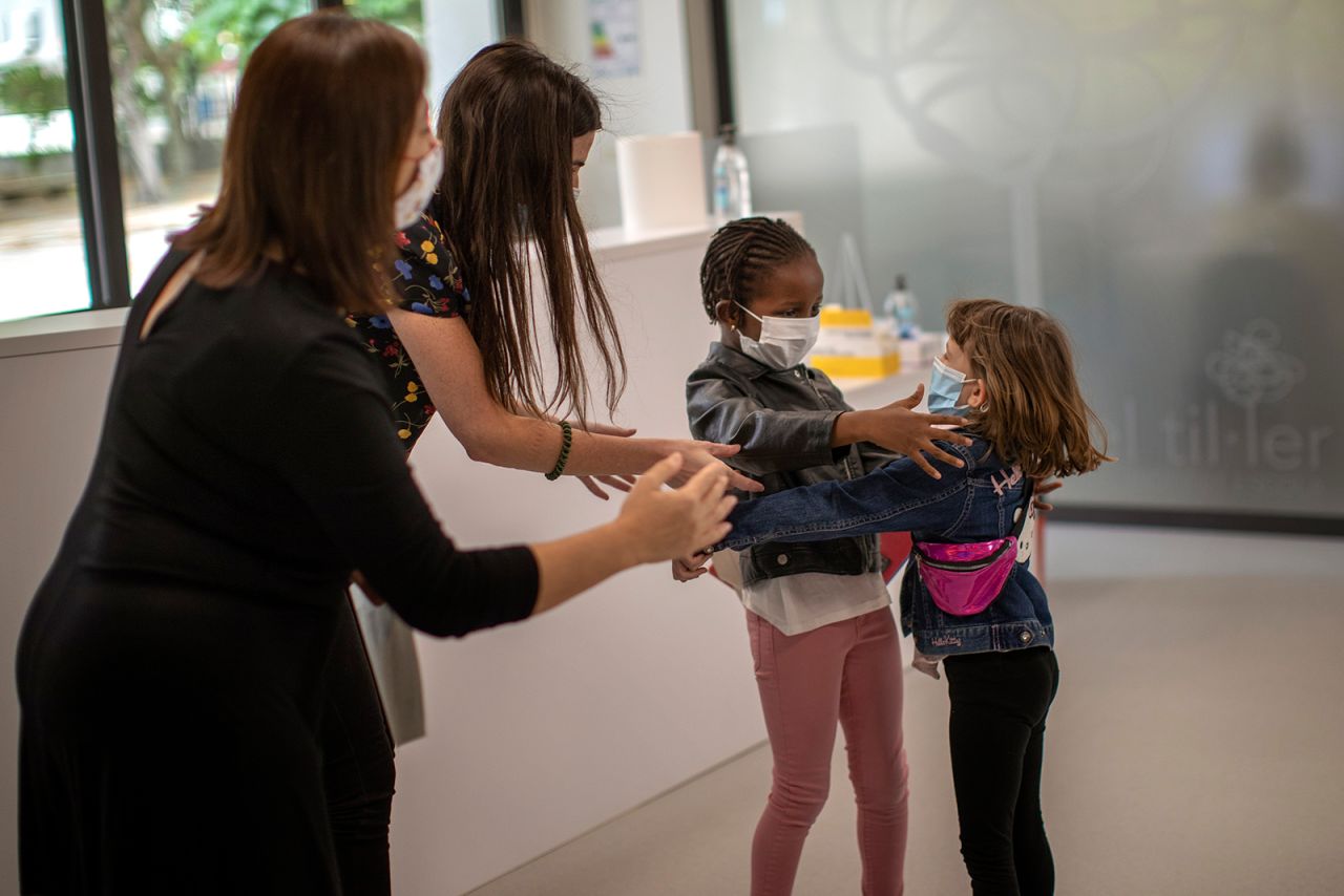 Teachers in Barcelona, Spain, try to prevent a hug between 6-year-olds Wendy Otin and Oumou Salam Niang as they meet on Monday, June 8. It was the first day of school since the country went on lockdown <a href="https://www.cnn.com/2020/03/19/world/gallery/novel-coronavirus-outbreak/index.html" target="_blank">because of the novel coronavirus.</a>
