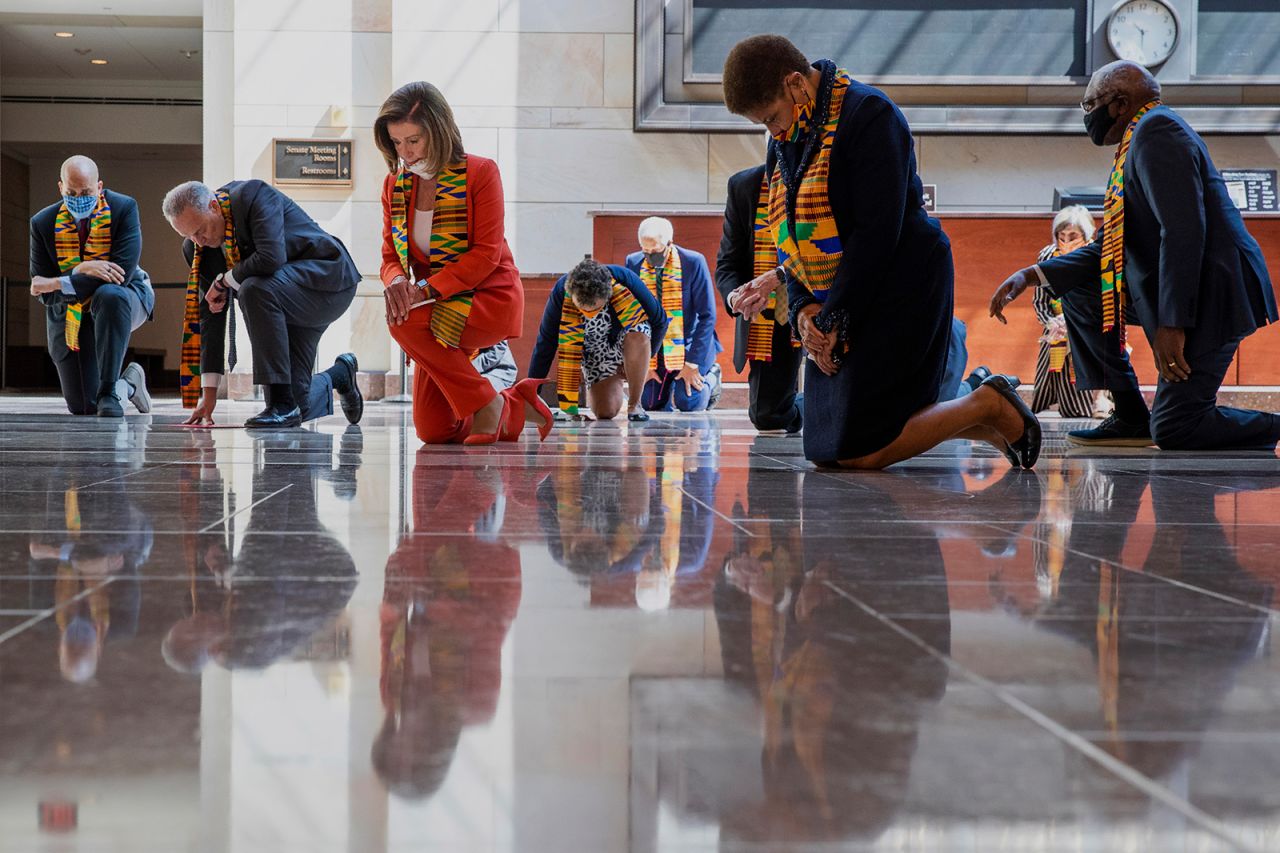 About two dozen Democratic lawmakers, including House Speaker Nancy Pelosi and Senate Minority Leader Chuck Schumer, kneel in silence for eight minutes and 46 seconds as they pay tribute to George Floyd on Monday, June 8. <a href="https://www.cnn.com/2020/06/08/politics/democrats-criticized-kente-cloth-trnd/index.html" target="_blank">They wore stoles made of Kente cloth</a>, drawing criticism from observers who felt they made the traditional African textile into a political prop.