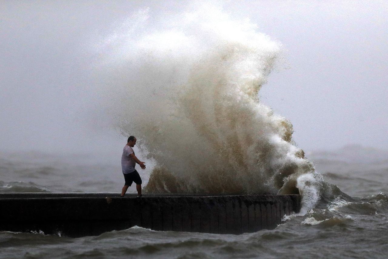 A wave crashes near a man in New Orleans as Tropical Storm Cristobal approached the Louisiana coast on Sunday, June 7. 