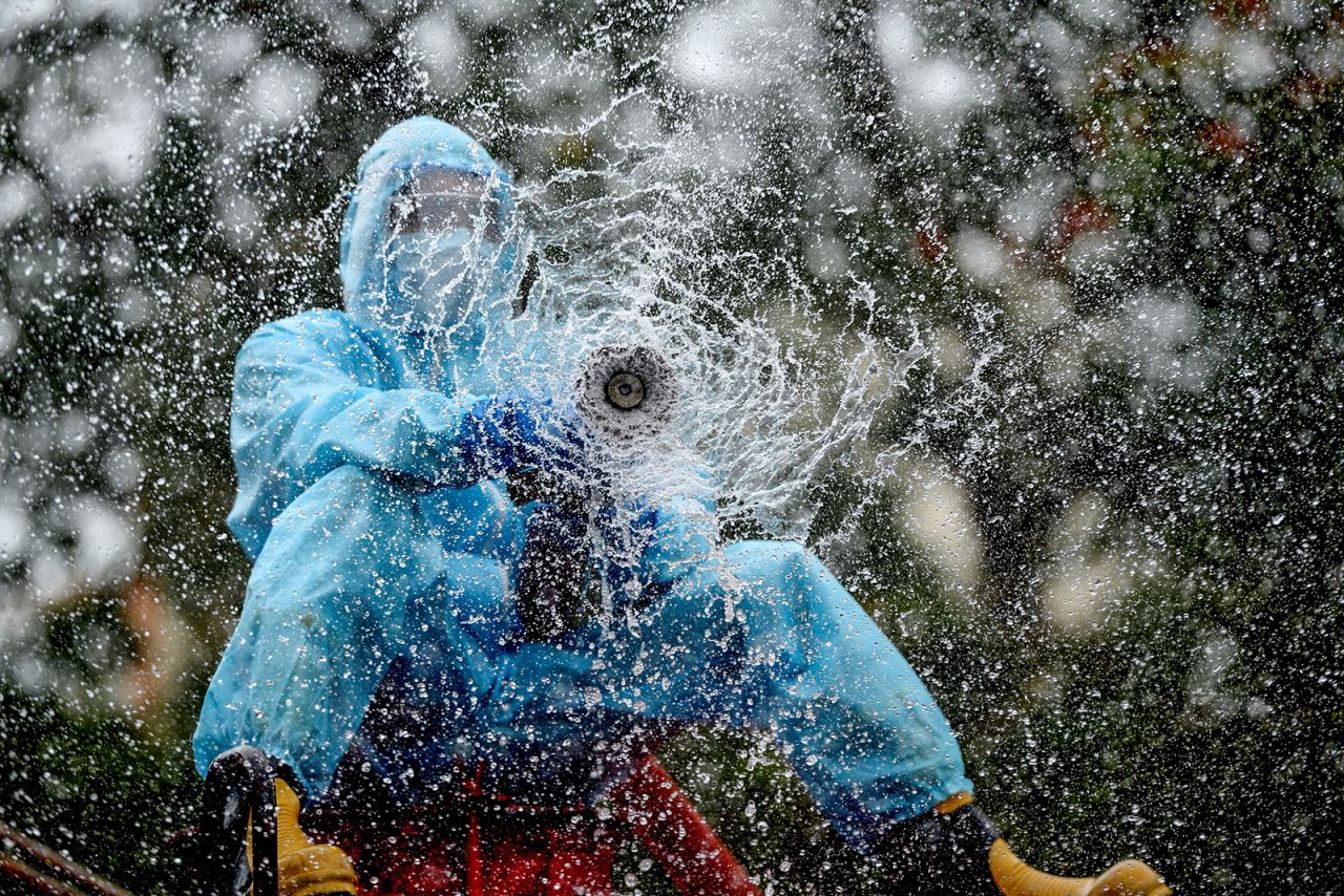 A firefighter in Chennai, India, sprays disinfectant to help prevent the spread of the coronavirus on Thursday, June 11. <em>Correction: This caption has been updated to correct the month.</em>