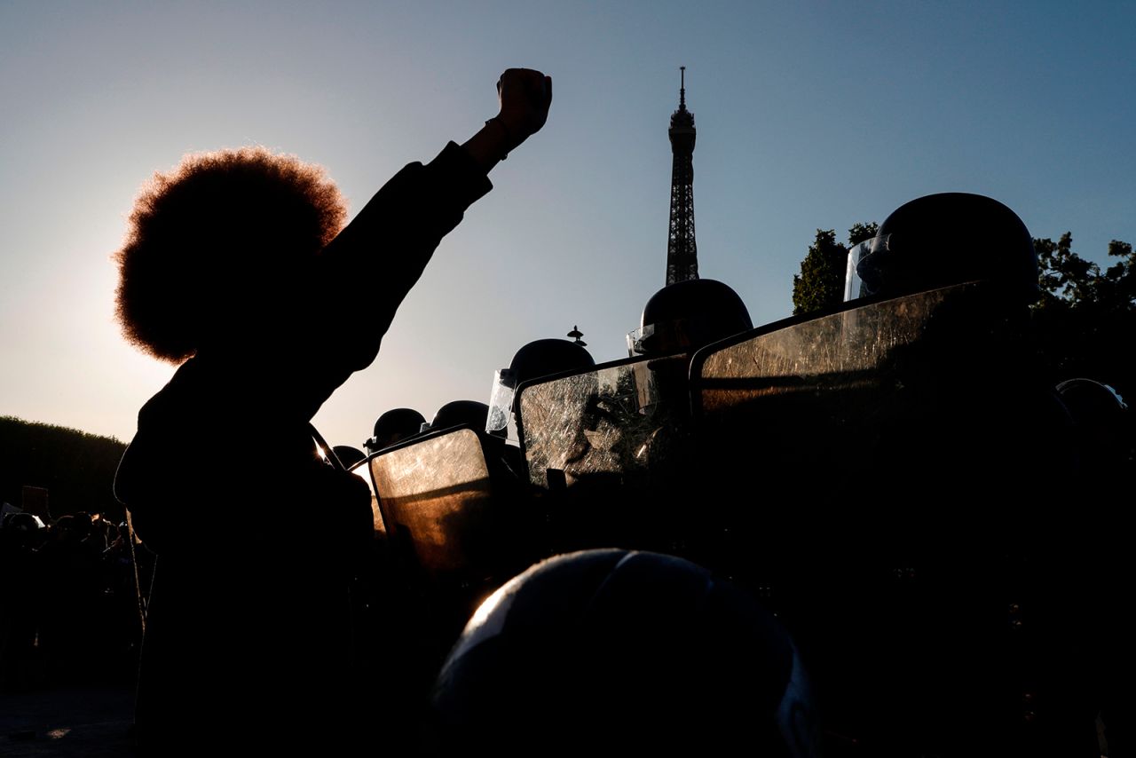 A protester raises a fist in front of police during a Black Lives Matter rally in Paris on Saturday, June 6. <a href="http://www.cnn.com/2020/06/06/world/gallery/intl-george-floyd-protests/index.html" target="_blank">See more photos of worldwide protests</a>