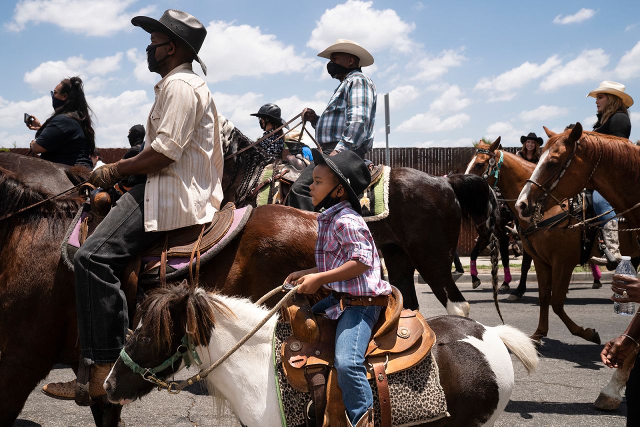 A young boy in Compton, California, rides with the Compton Cowboys during a "peace ride" for George Floyd on Sunday, June 7.