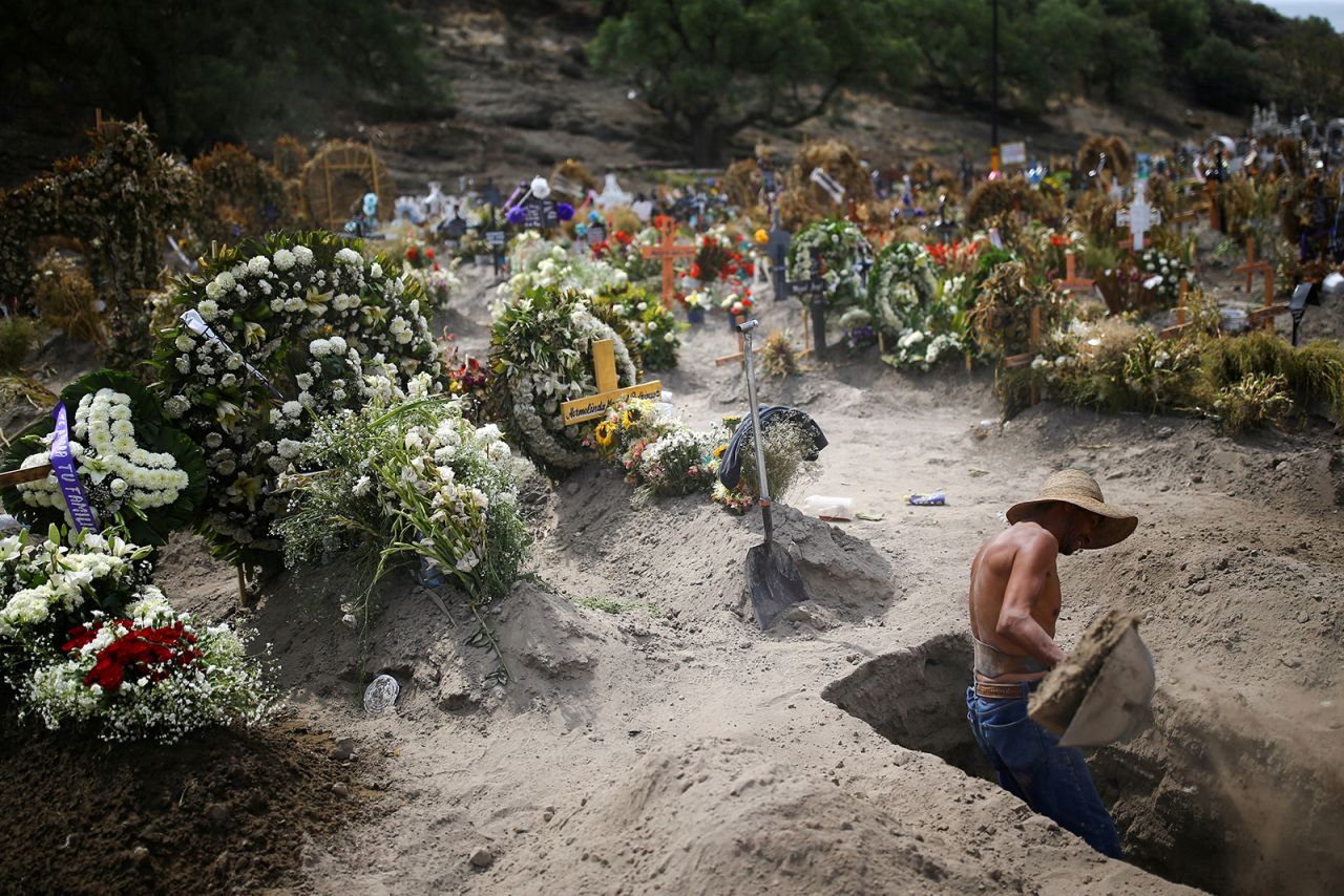 A cemetery worker digs new graves at the Xico cemetery on the outskirts of Mexico City on Wednesday, June 10. <a href="https://www.cnn.com/2020/06/11/americas/mexico-coronavirus-paramedics-intl/index.html" target="_blank">Mexico is suffering because of the coronavirus,</a> with 129,184 confirmed cases and 15,357 confirmed deaths as of Wednesday. Health officials say the true numbers are likely much higher than that.
